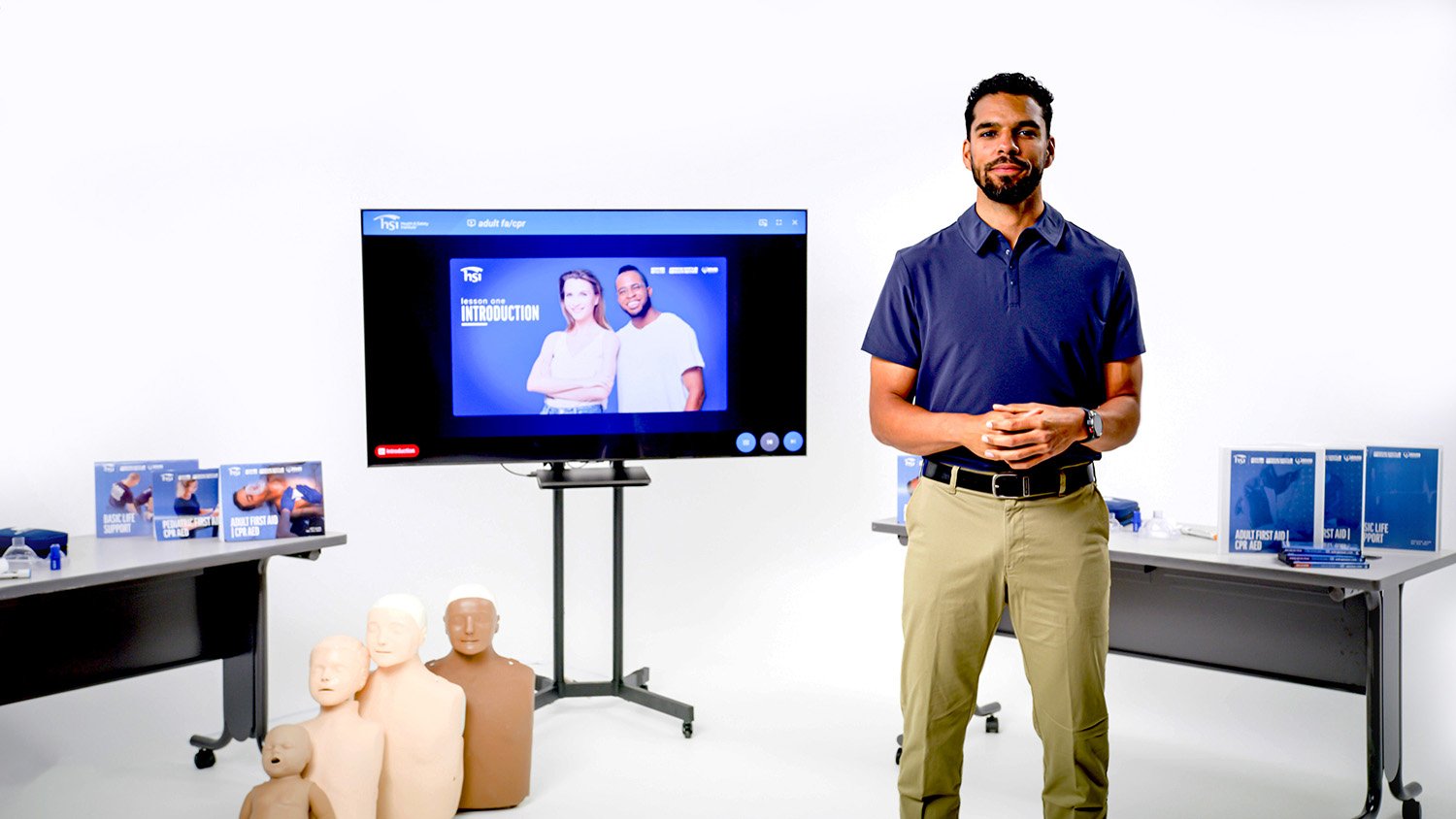 Instructor standing infront of TV on white background